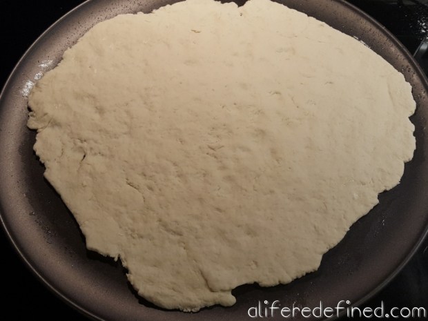 Press dough on pan